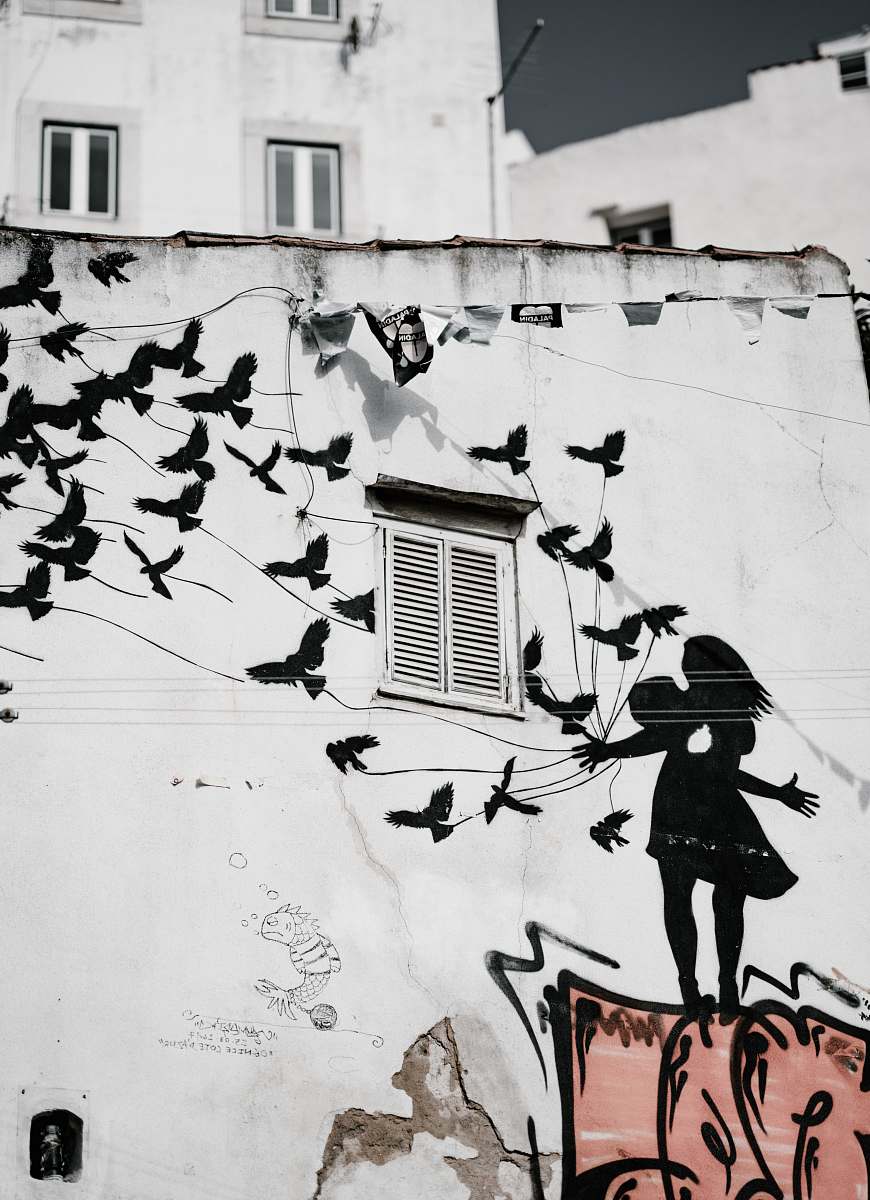 window man and woman kissing each other with flight of bird graffiti shutter